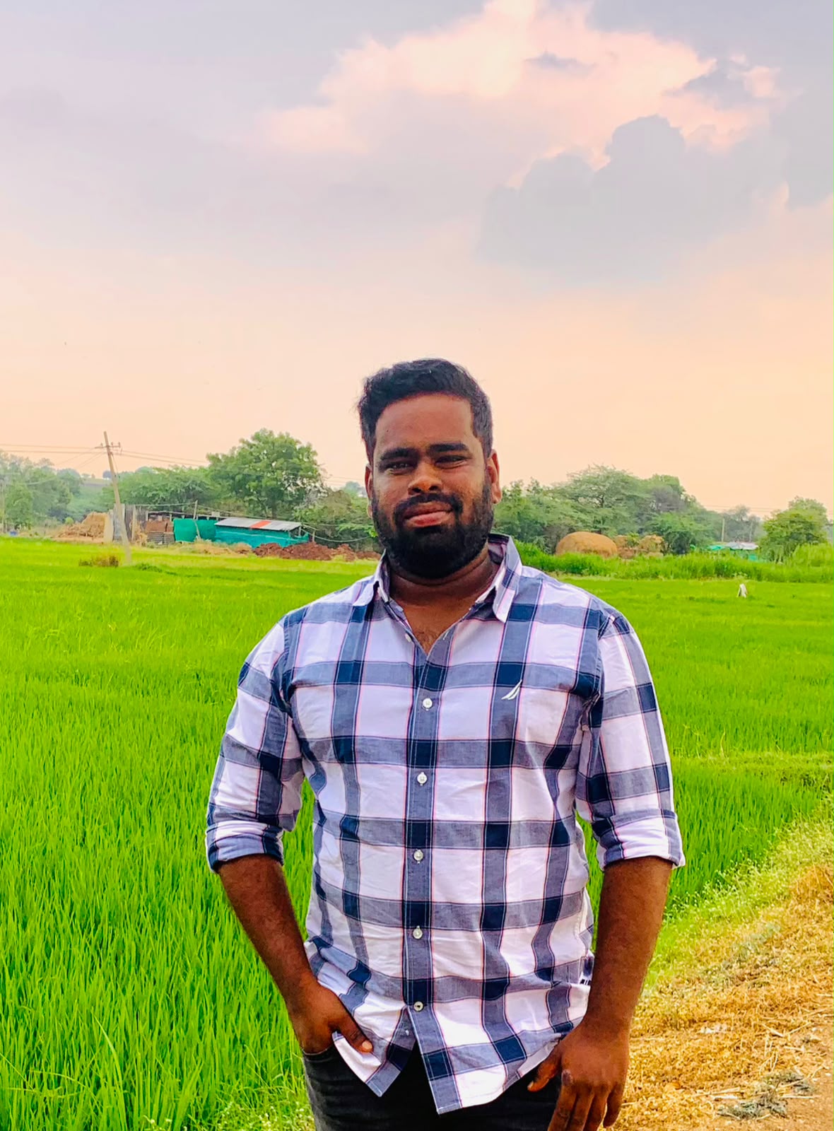 Founder of Chevella Properties standing in a paddy field